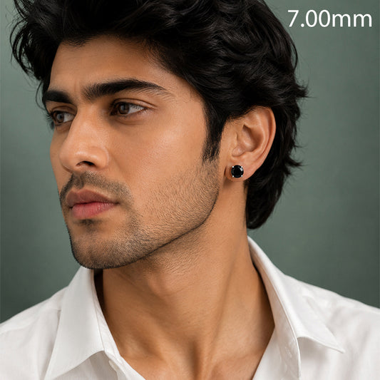 A close-up of a man wearing a small black stud earring