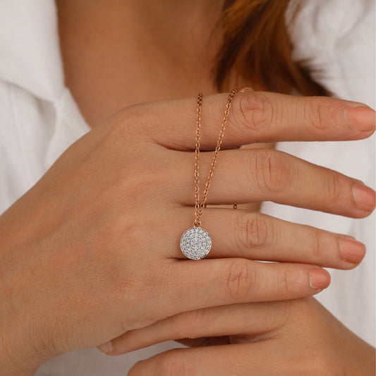 Hand wearing a gold necklace