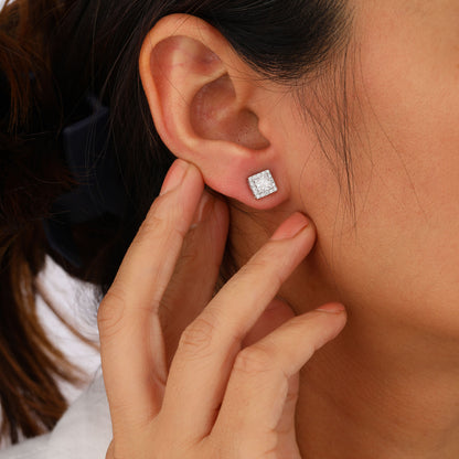 Close-up of a person wearing a diamond stud earring 