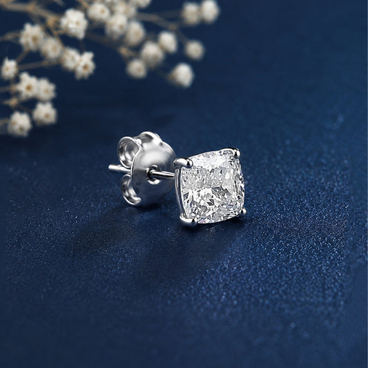Diamond earring on a dark blue background with white flowers.