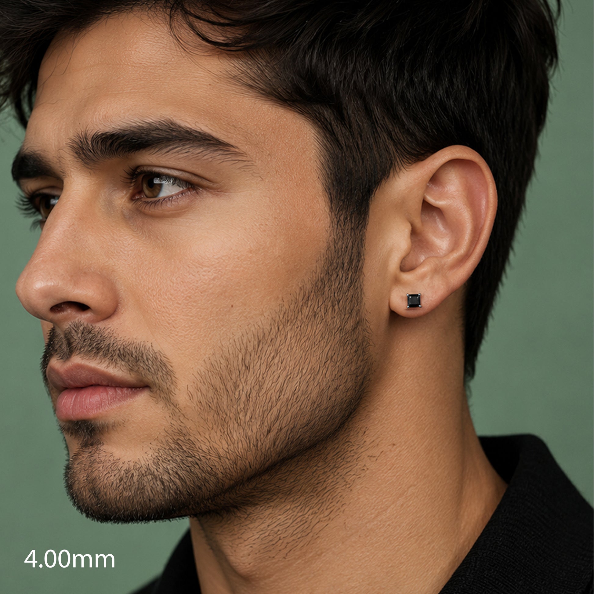 Close-up of a man wearing a black earring with a green background