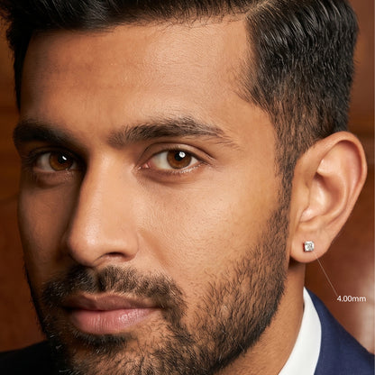 Close-up of a man wearing a diamond earring with a blurred background