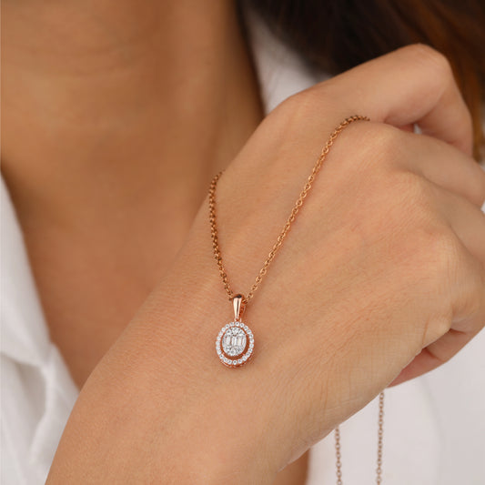 Rose gold necklace with a diamond pendant held by a hand 