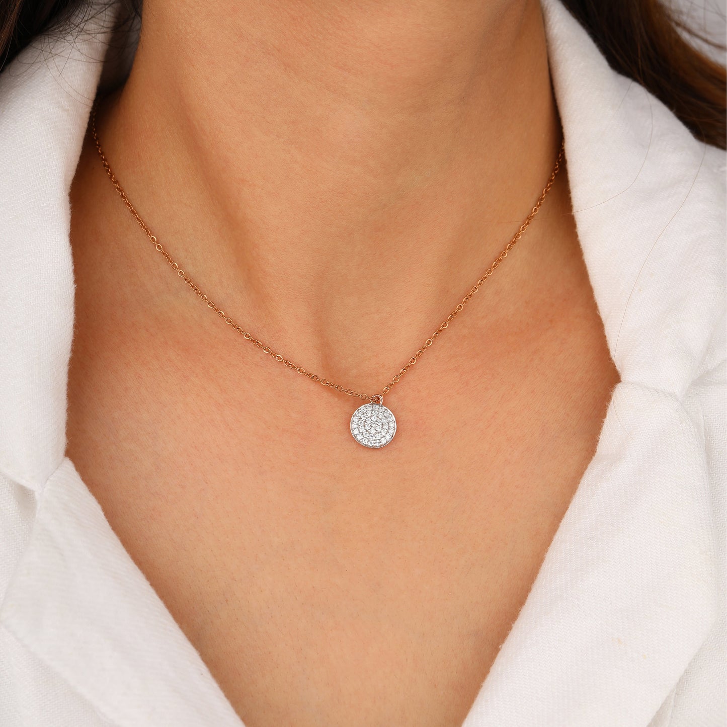 Necklace with a round, diamond-studded pendant