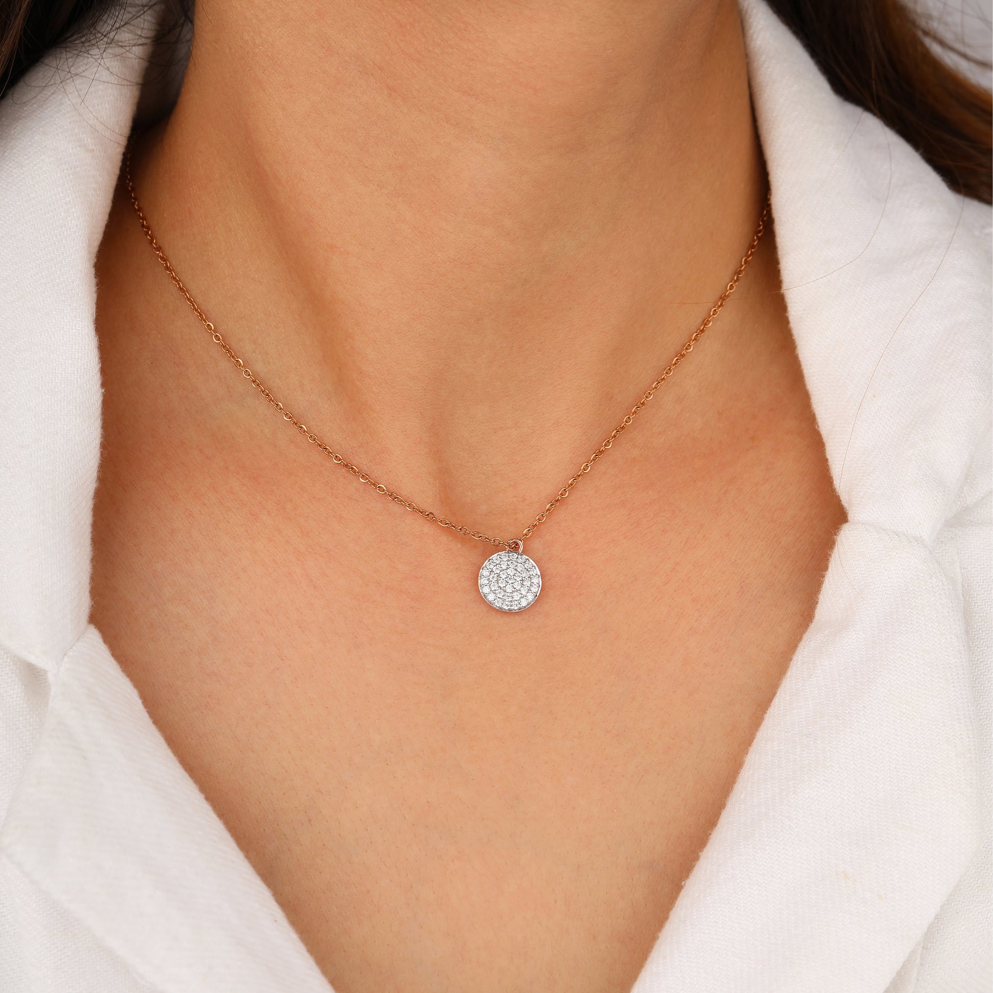 Necklace with a round, diamond-studded pendant
