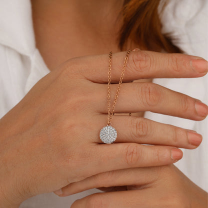 Hand wearing a gold necklace 