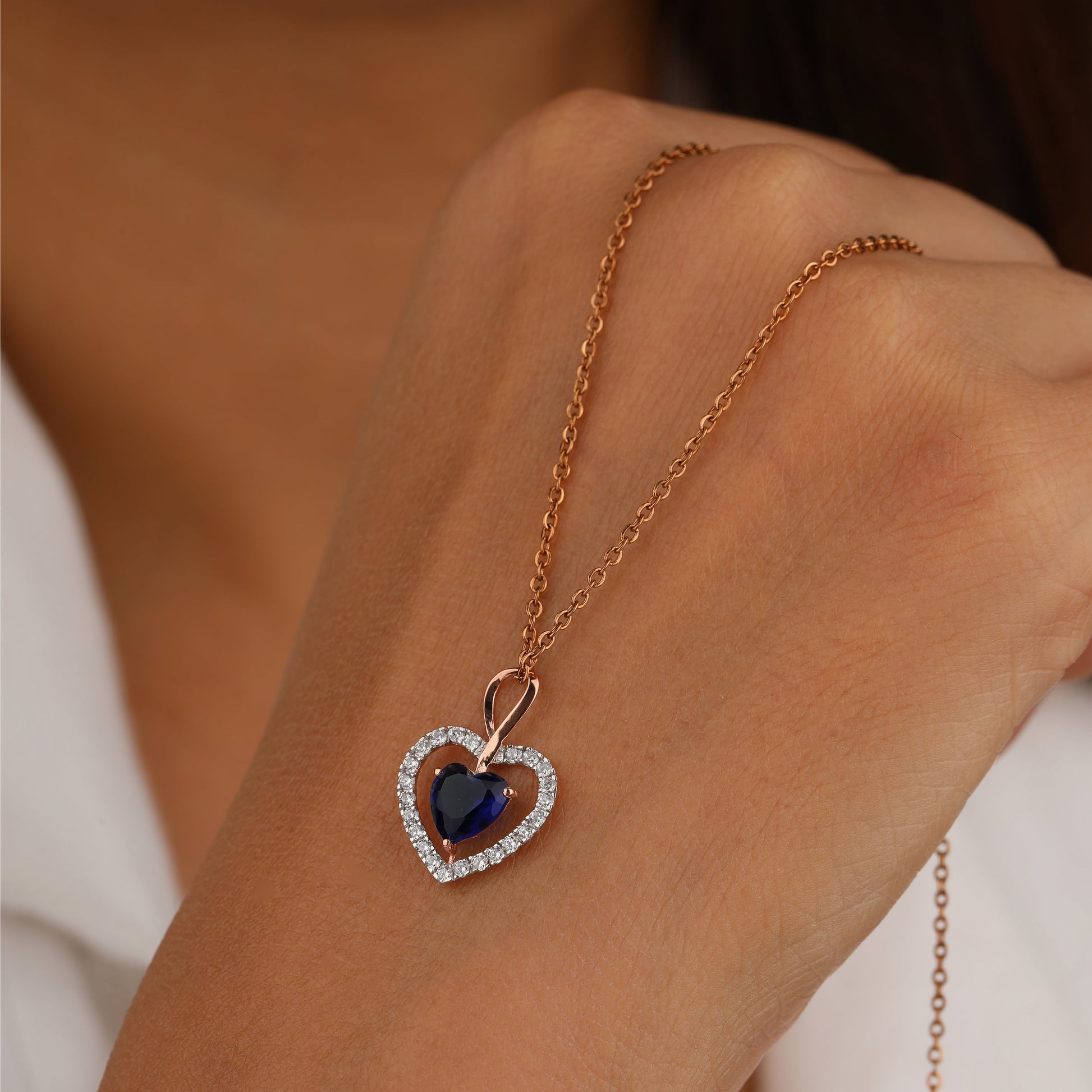 Heart-shaped necklace with a blue gemstone