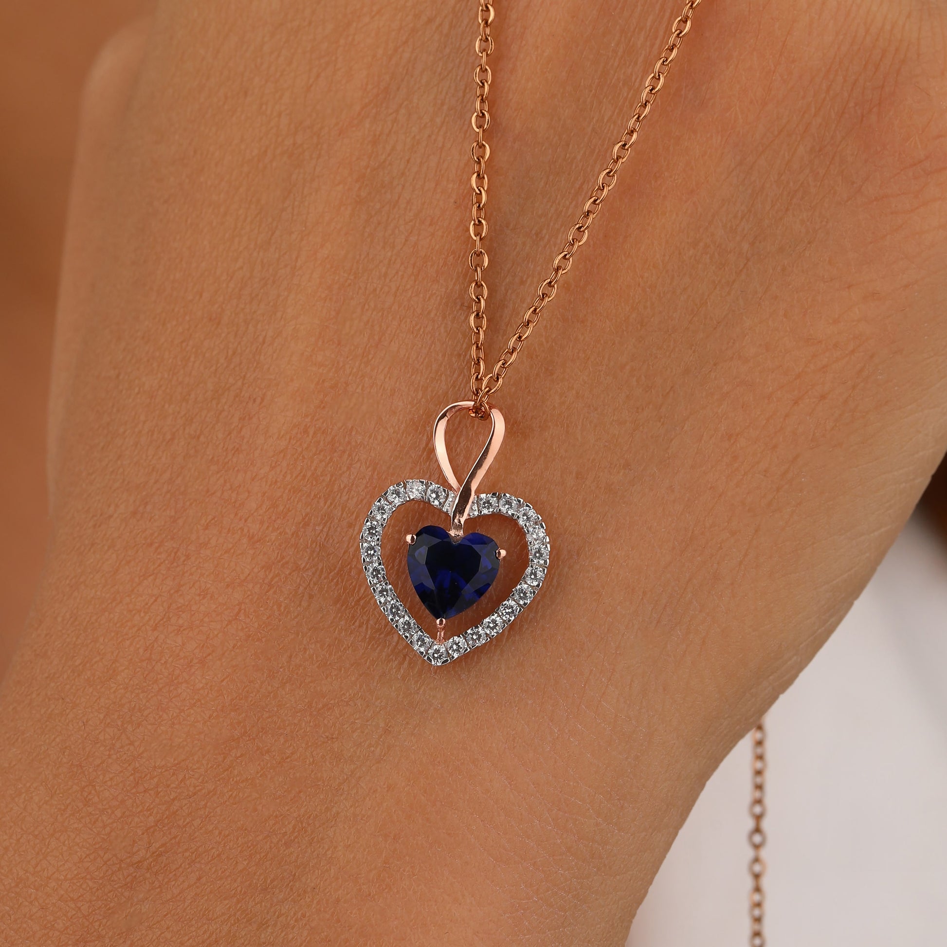 Heart-shaped necklace with a blue gemstone 