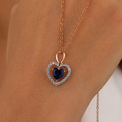 Heart-shaped necklace with a blue gemstone 