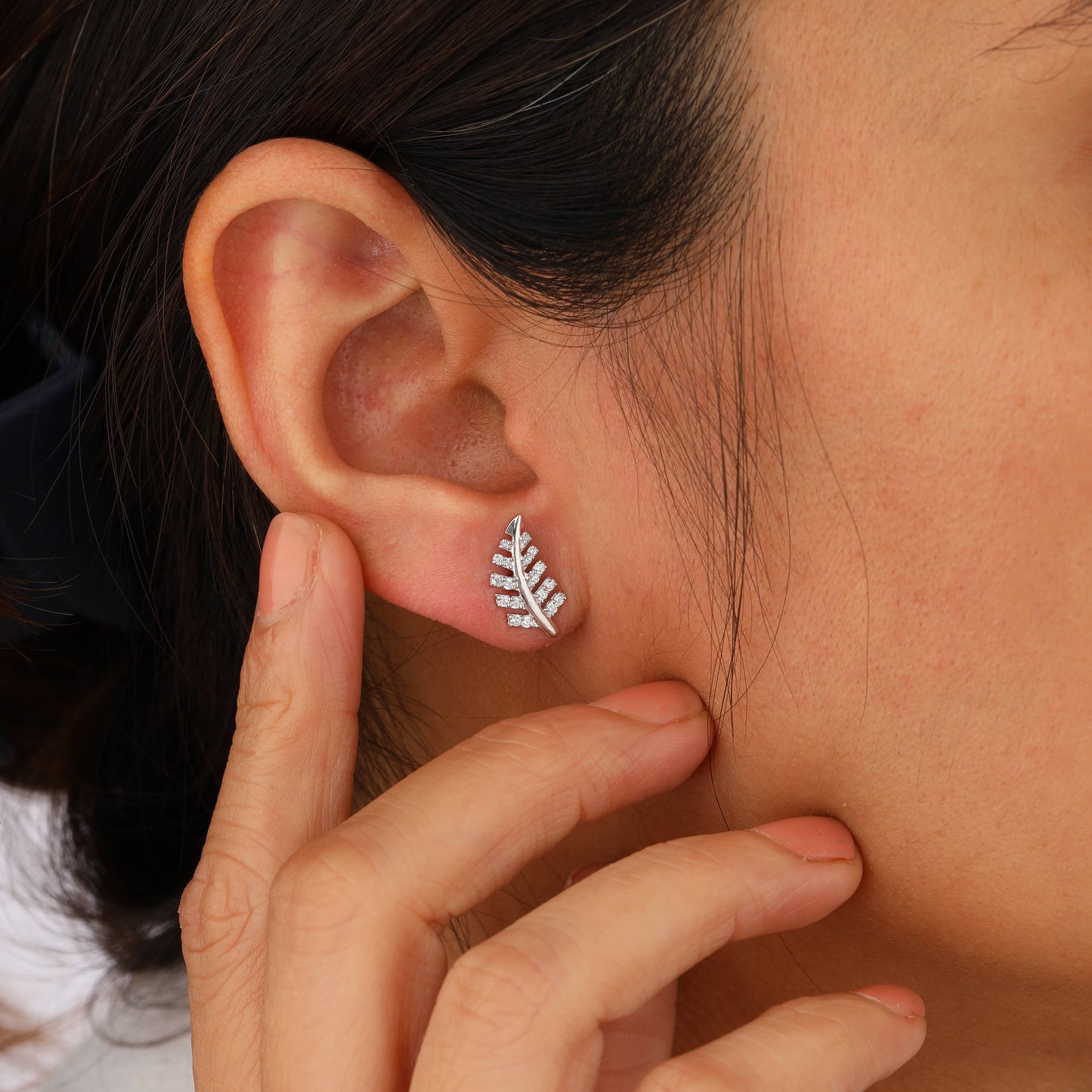 chinar leaf earrings on model ear