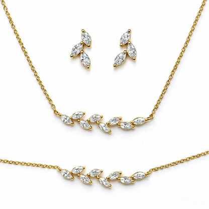 Gold plated necklace and earrings set on a white background