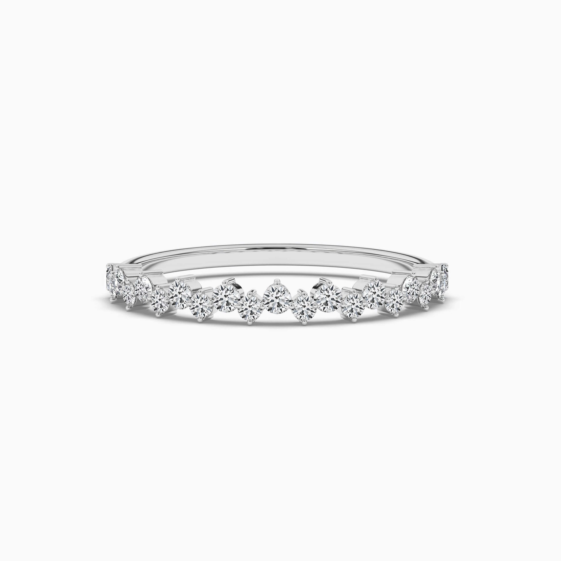Delicate silver ring with small diamonds on a white background