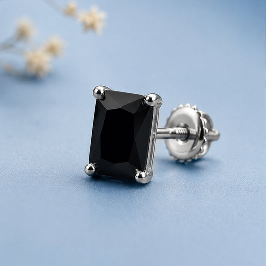 Black gemstone earring on a light blue background