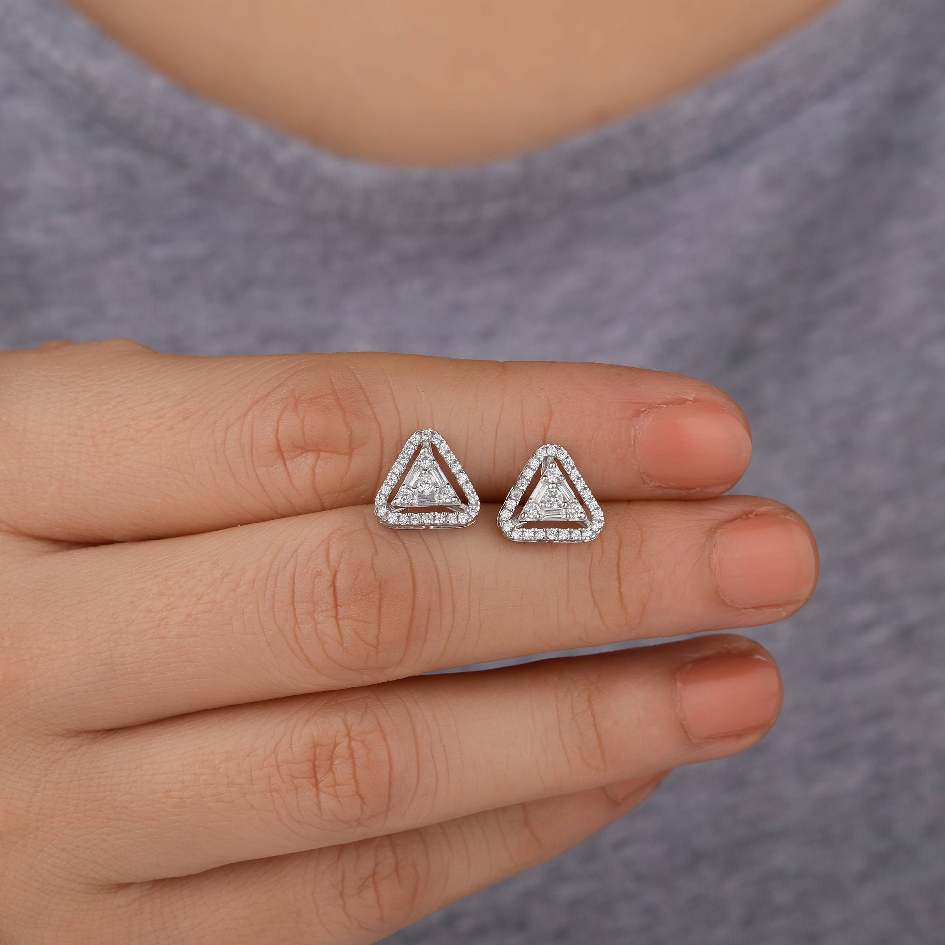 Triangle-shaped earrings held 