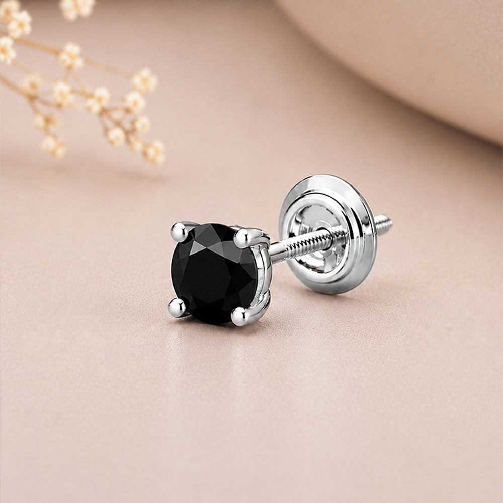 A single stud earring with a faceted black gemstone in a silver four-prong setting