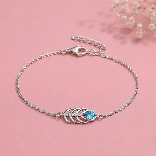 Silver chain bracelet with a central leaf-like motif and a bright blue oval stone
