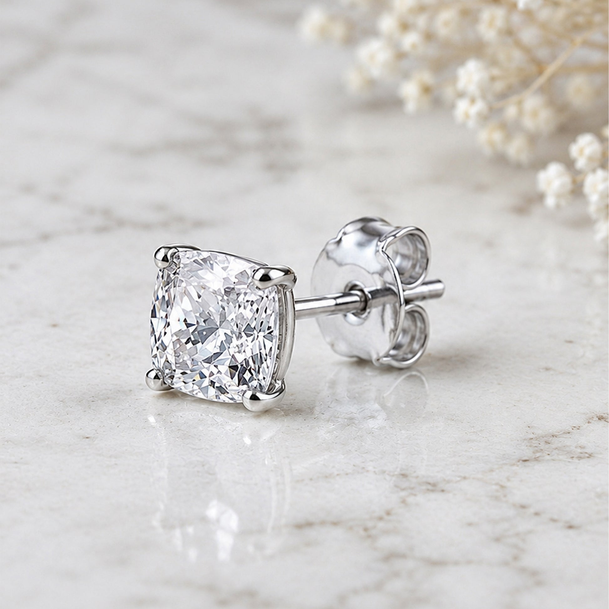 Diamond stud earring on a marble surface