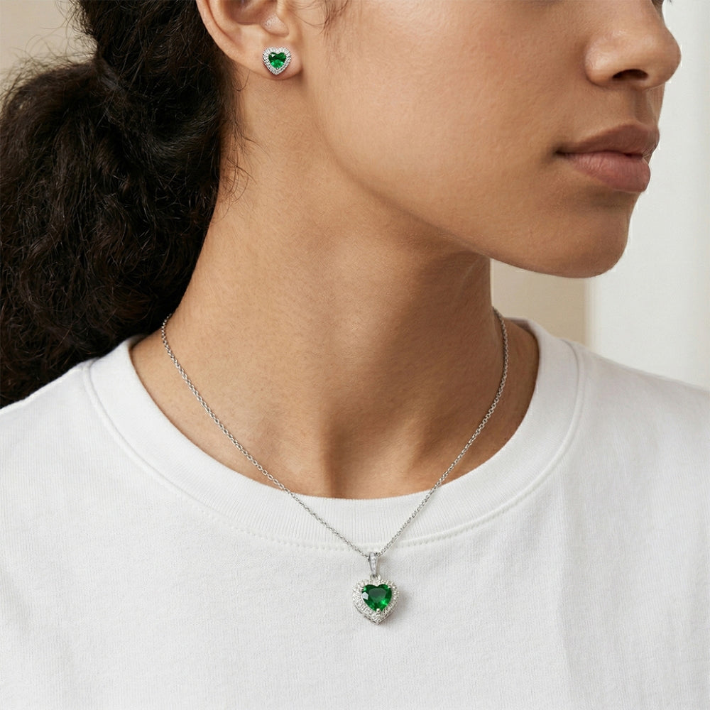 silver necklace with a green heart pendant and matching earrings.