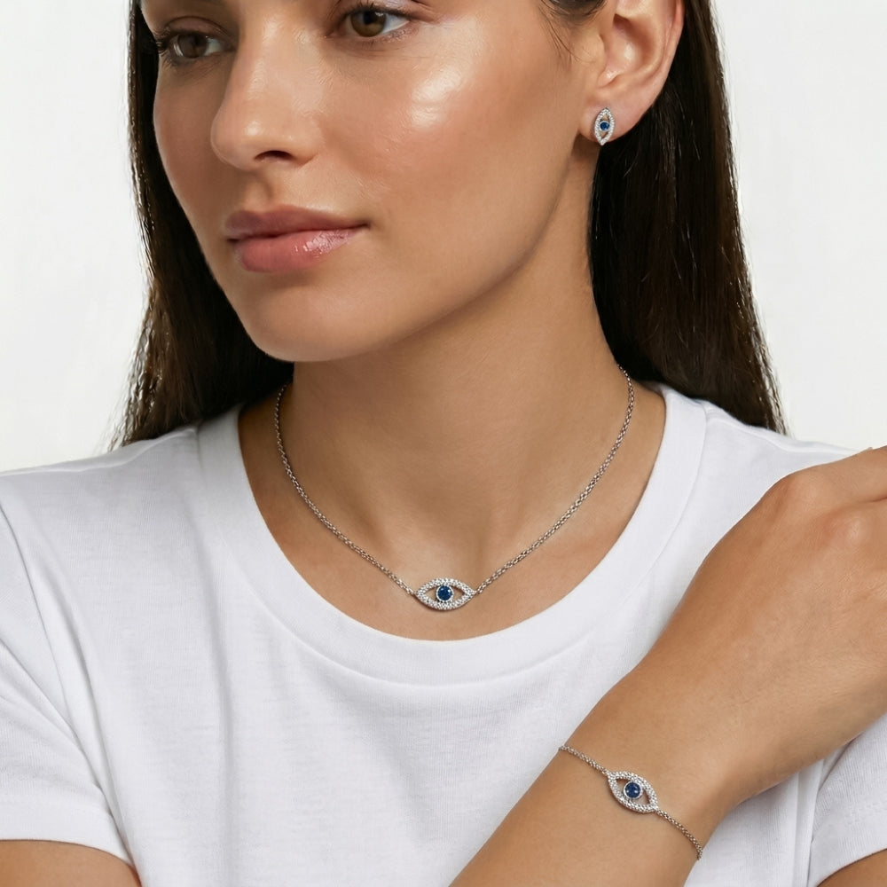 Woman wearing a silver necklace and bracelet with an eye 