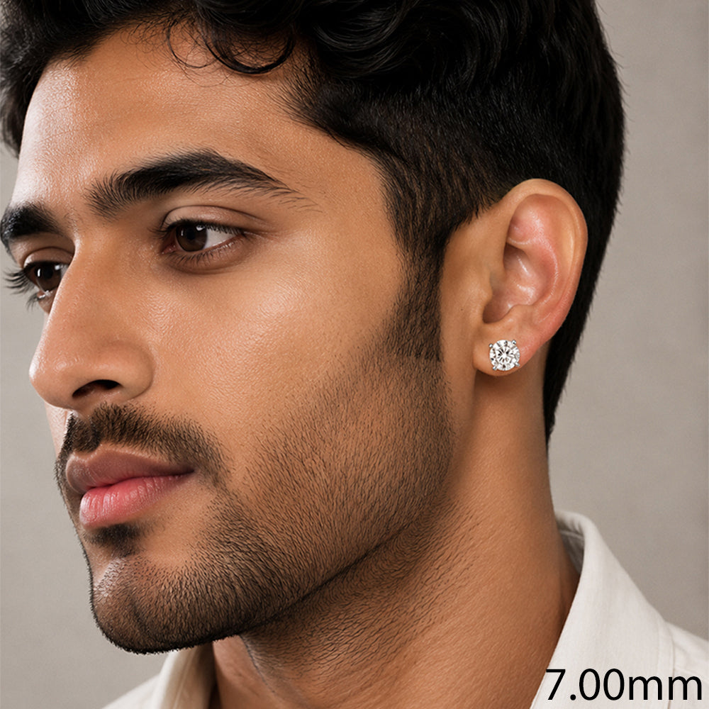 A close-up of a man wearing a small round stud earring on his ear,