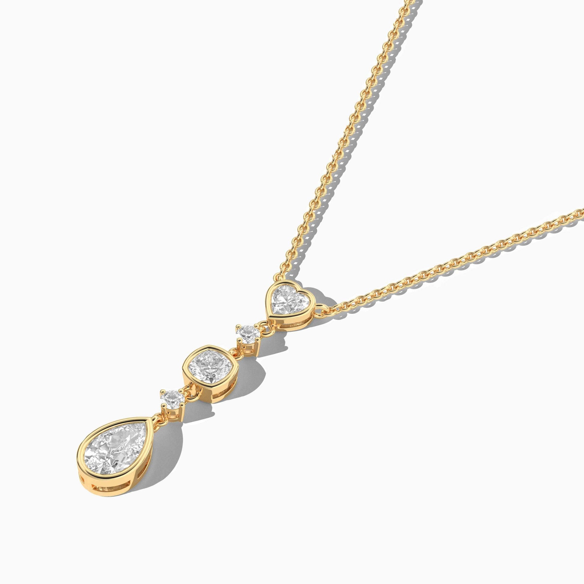 Gold necklace with a teardrop-shaped pendant on a white background