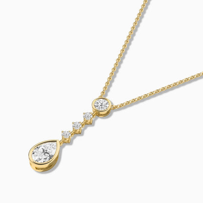 Gold necklace with a teardrop-shaped pendant on a white background