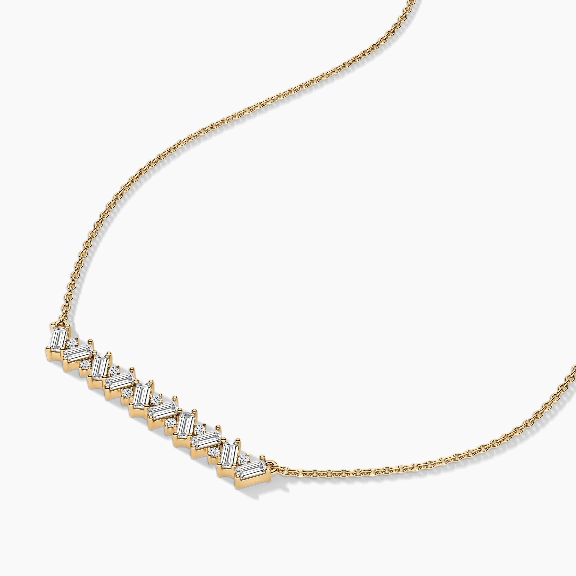 Gold necklace with diamond accents on a white background