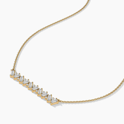 Gold necklace with diamond accents on a white background