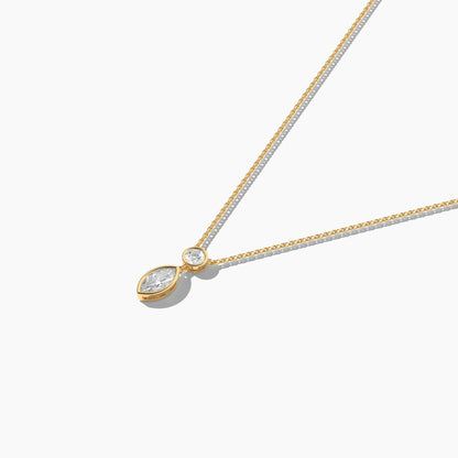 Gold necklace with a teardrop-shaped pendant on a white background