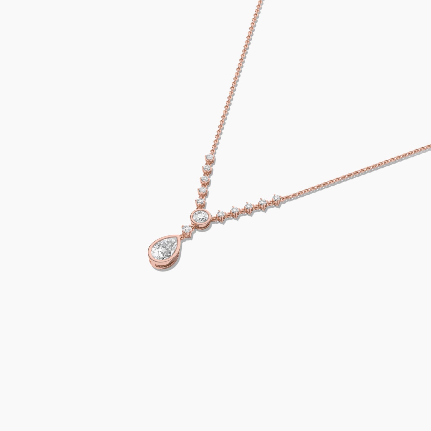 Rose gold necklace with a teardrop-shaped pendant on a white background