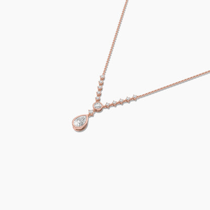Rose gold necklace with a teardrop-shaped pendant on a white background