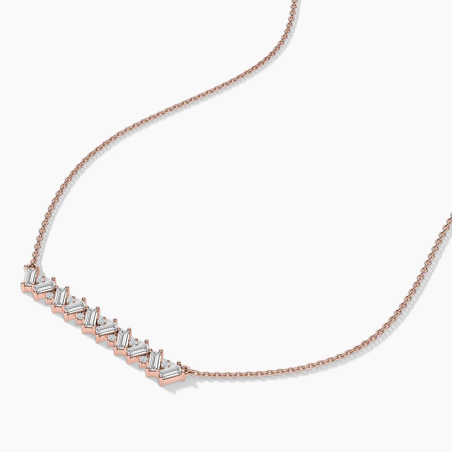 Rose gold necklace with diamond accents on a light gray background