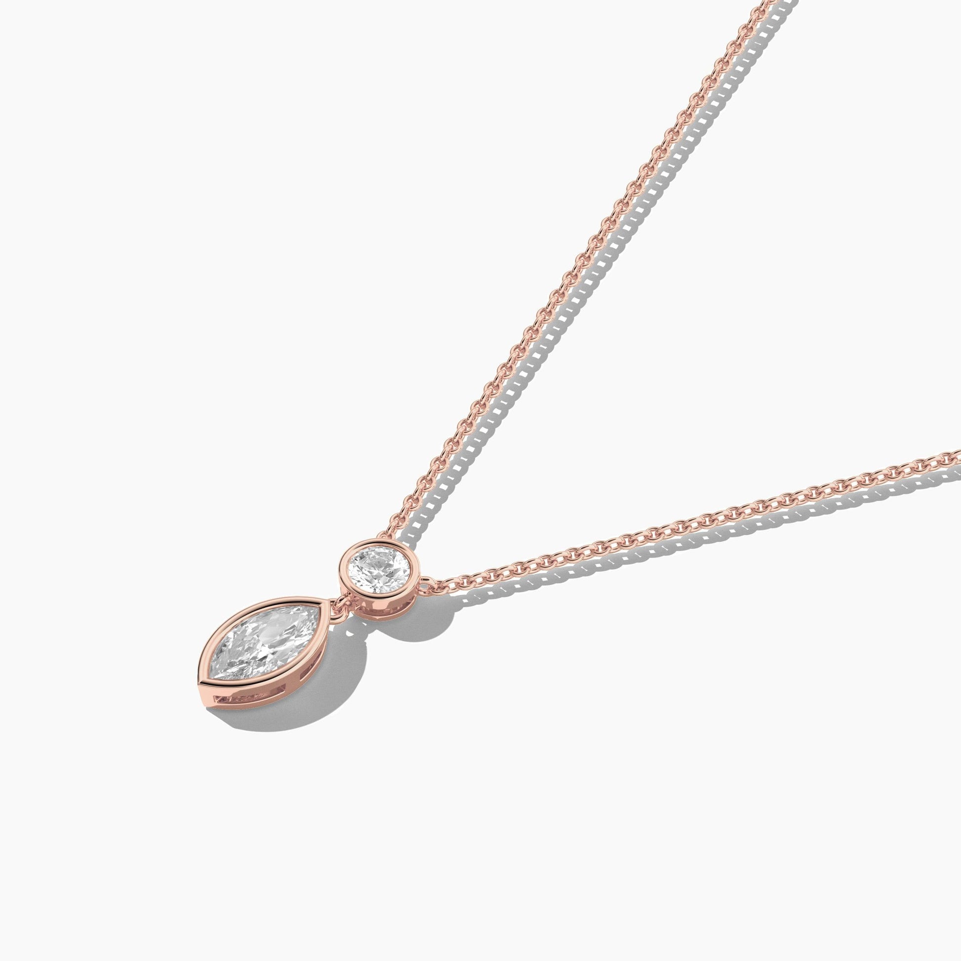 Rose gold necklace with a teardrop-shaped pendant on a white background