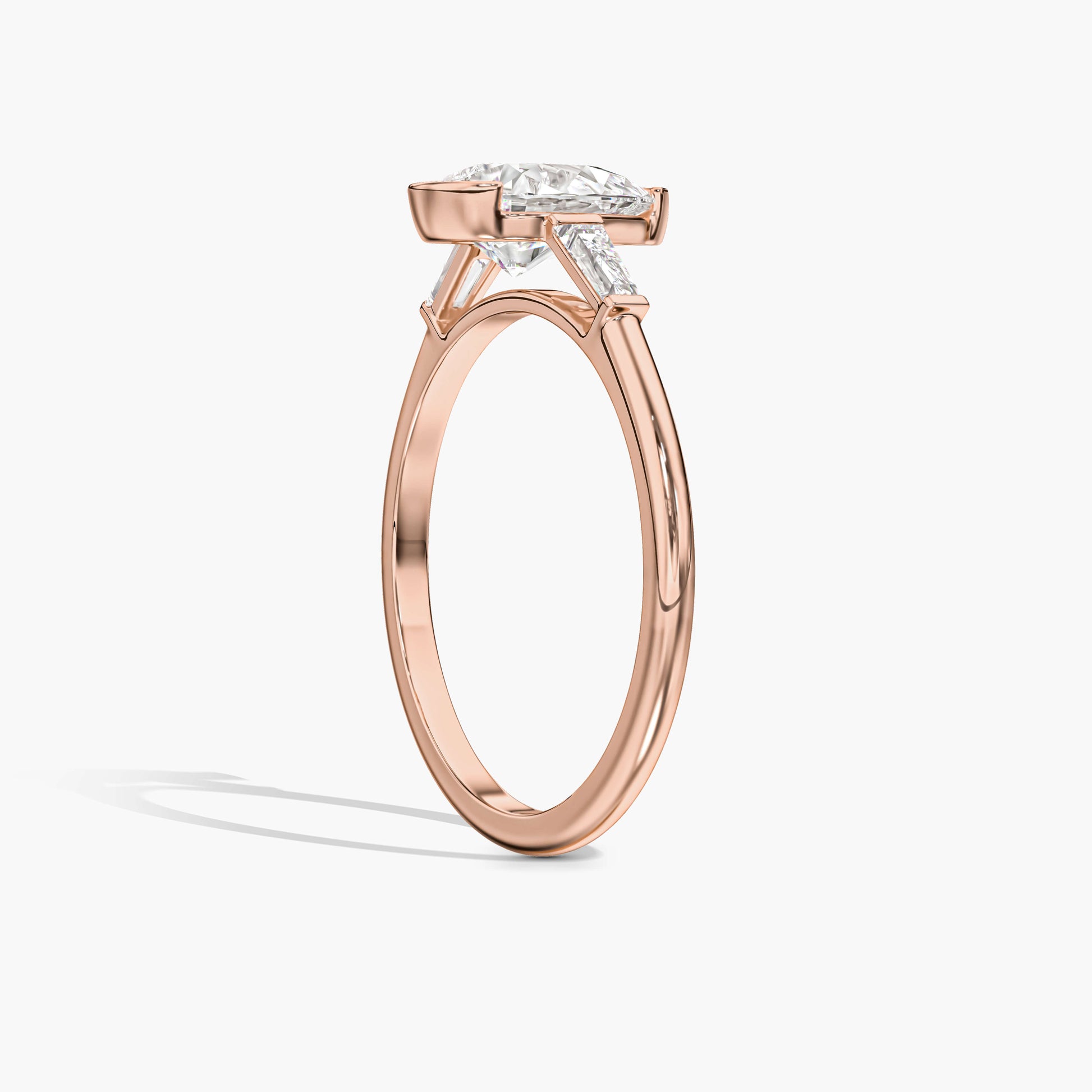 Rose gold ring with a diamond on a white background