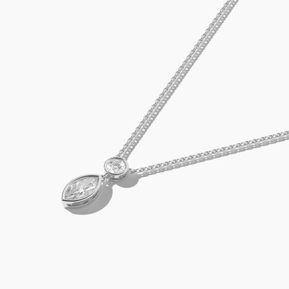 Silver necklace with a teardrop-shaped pendant on a white background