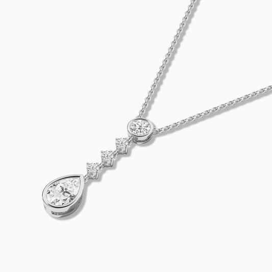 Silver necklace with a teardrop-shaped pendant on a white background