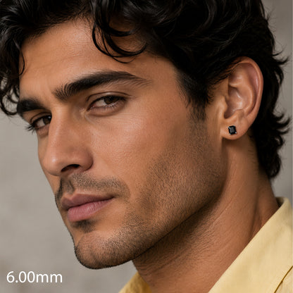 Close-up of a man wearing an earring with a neutral background