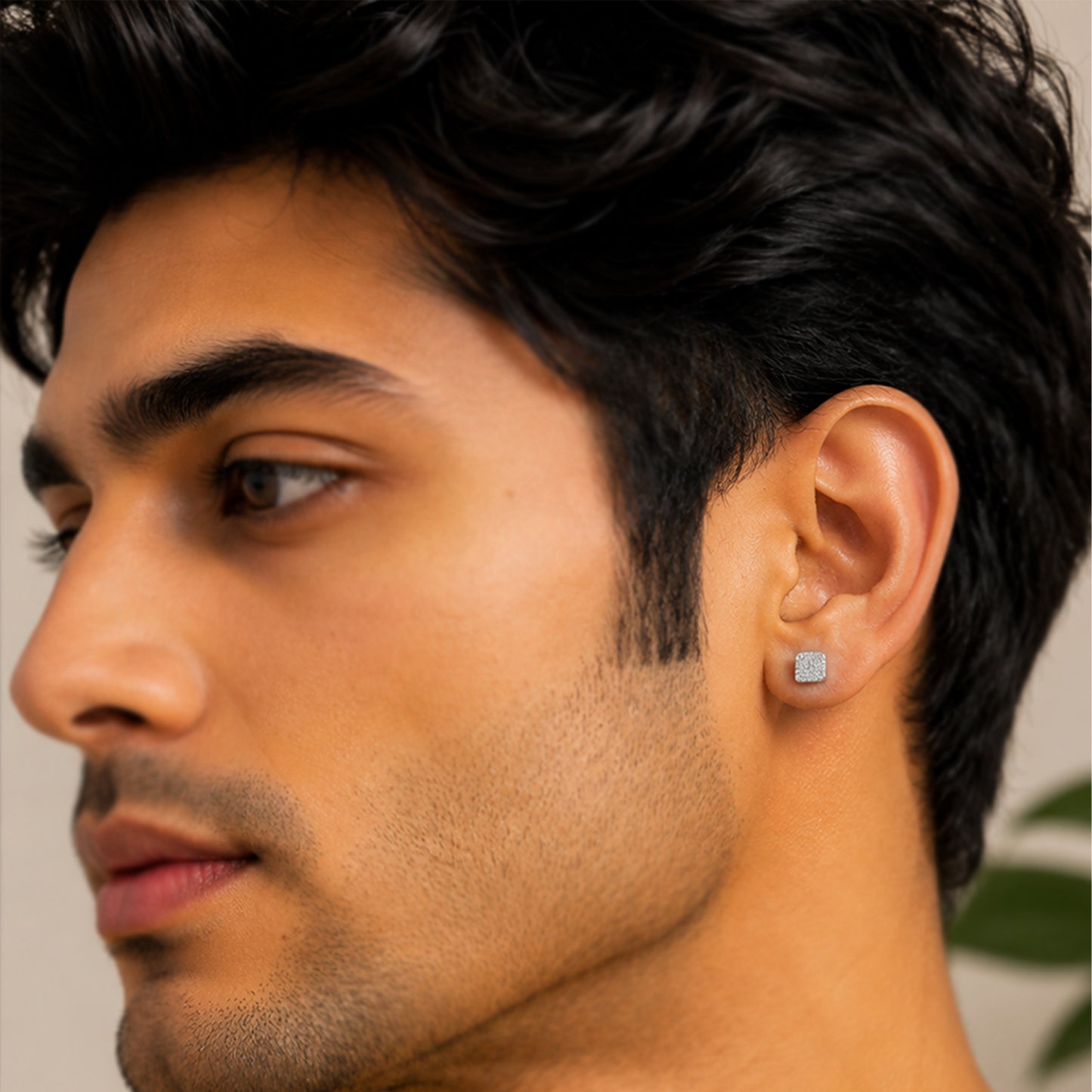 Close-up of a man wearing diamond stud earrings 