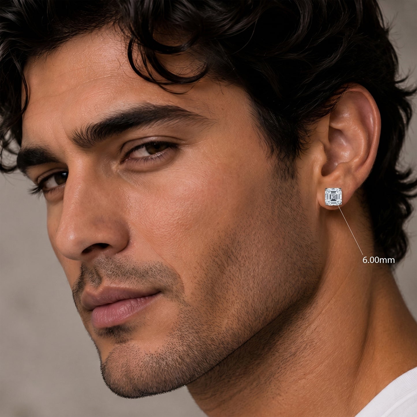 Close-up of a man wearing a diamond earring with a neutral background