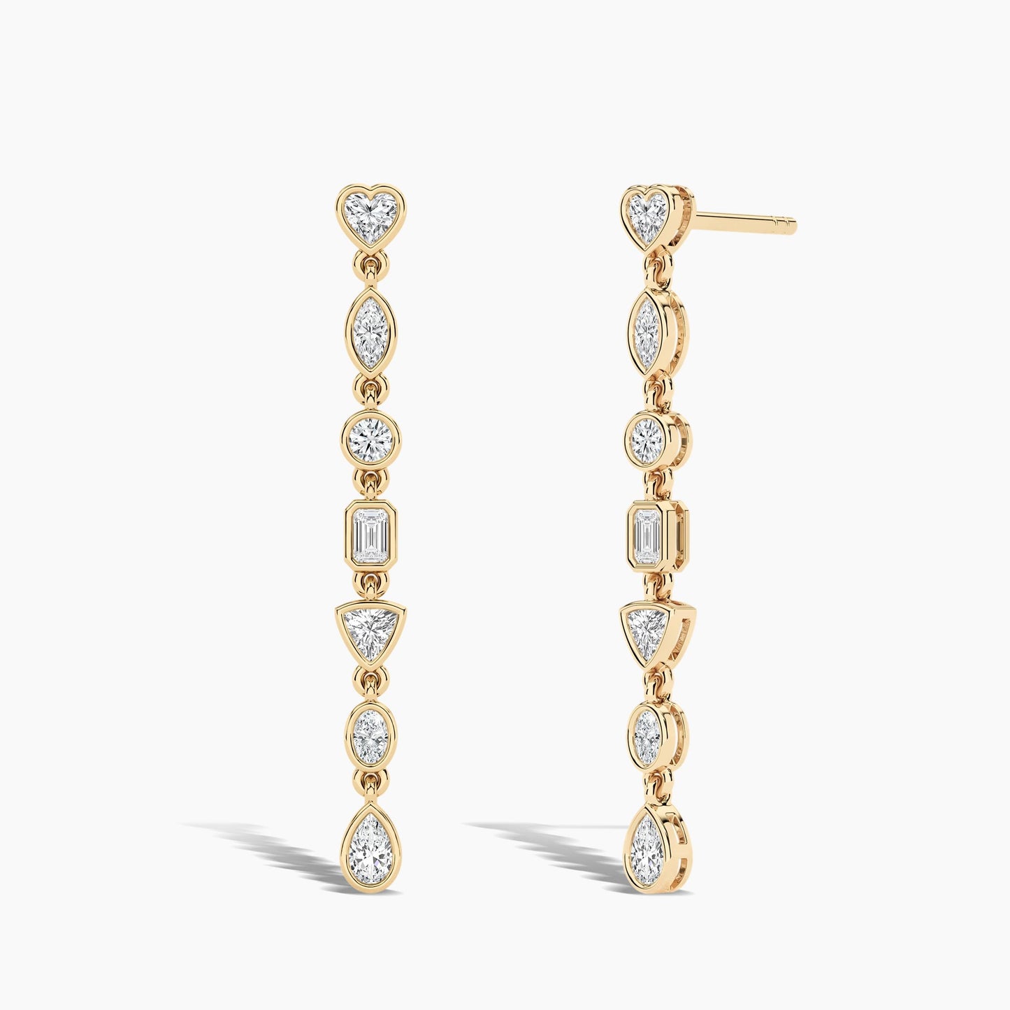 Gold earrings with clear gemstones on a white background
