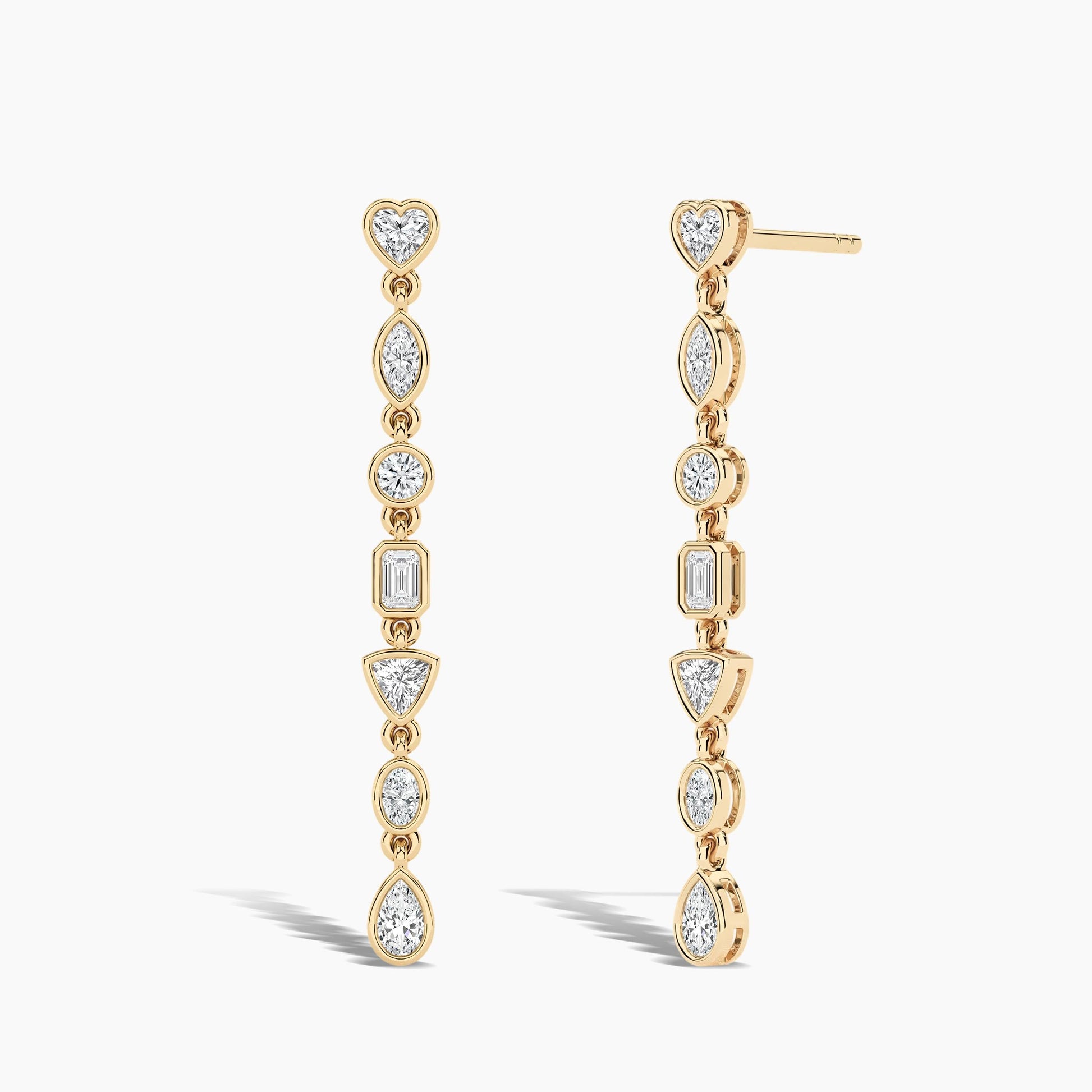 Gold earrings with clear gemstones on a white background