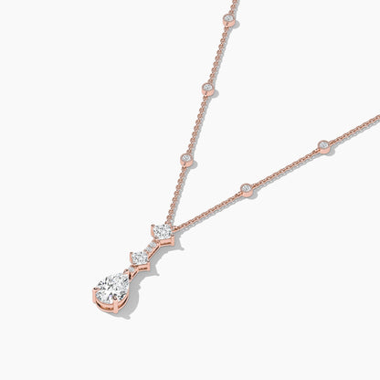 Rose gold necklace with a diamond pendant on a white background