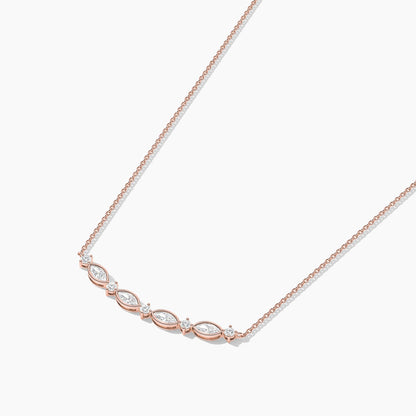 Rose gold necklace with diamond accents on a white background