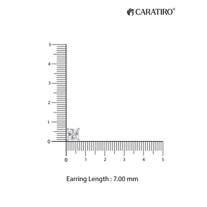 Diamond earring next to a ruler showing its length 