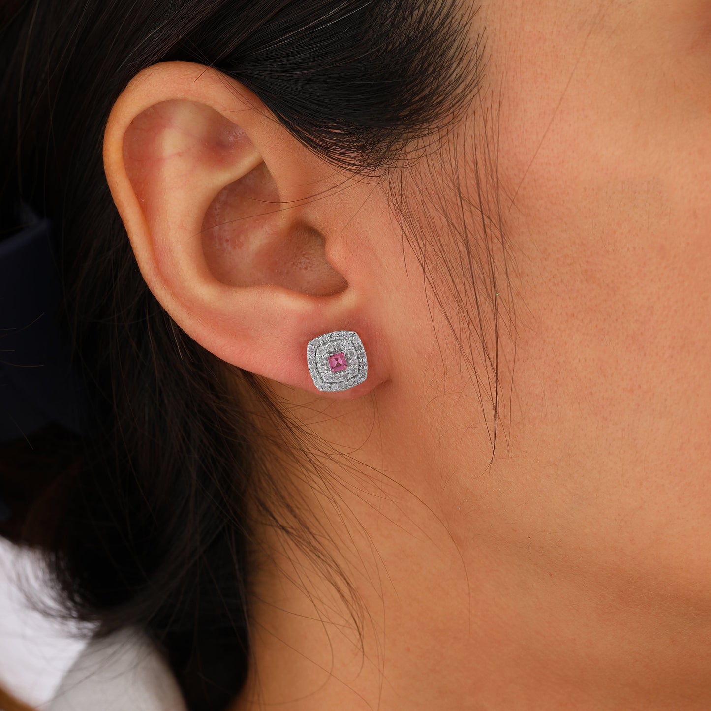 silver earring with a pink gemstone