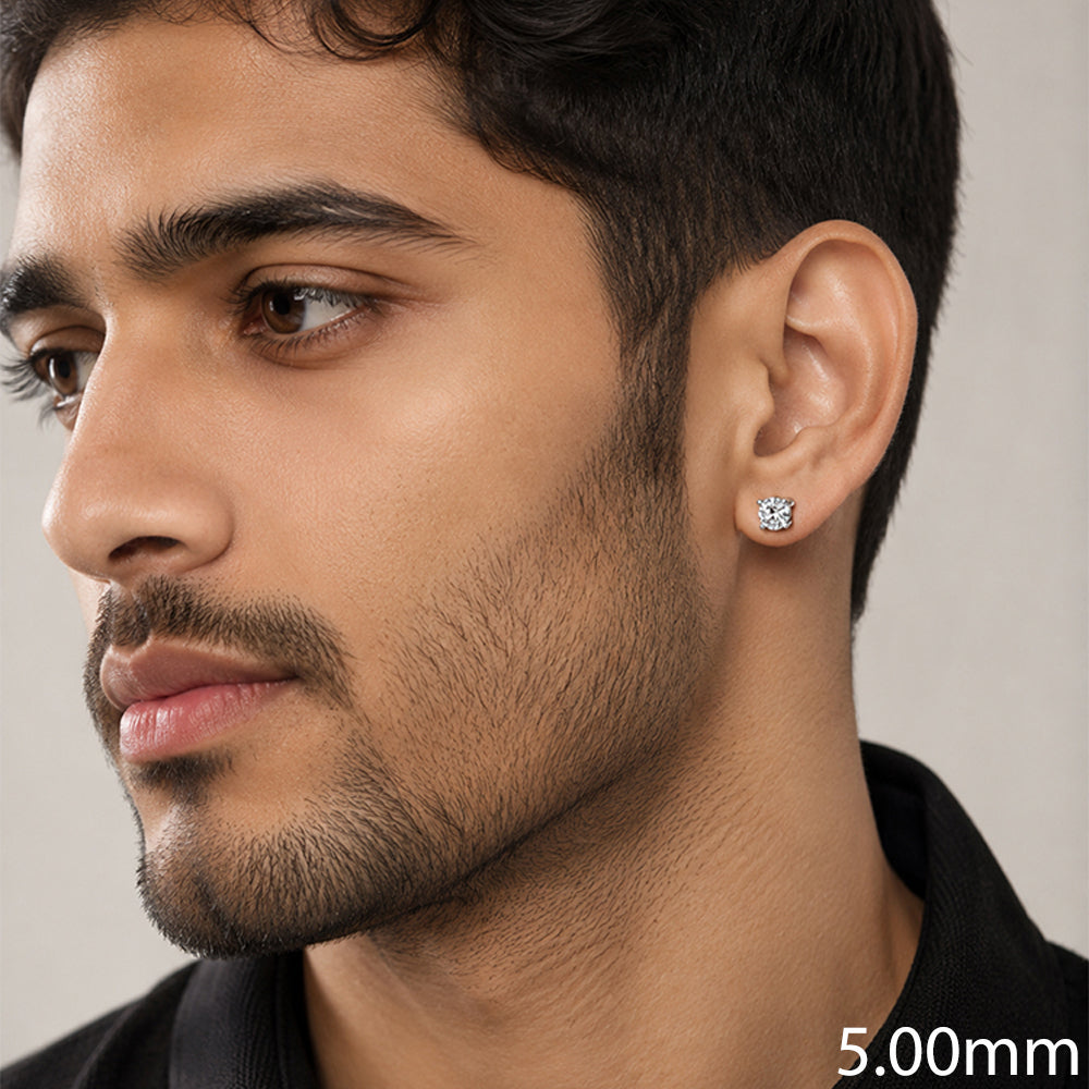 A close-up of a man wearing a small round stud earring on his ear