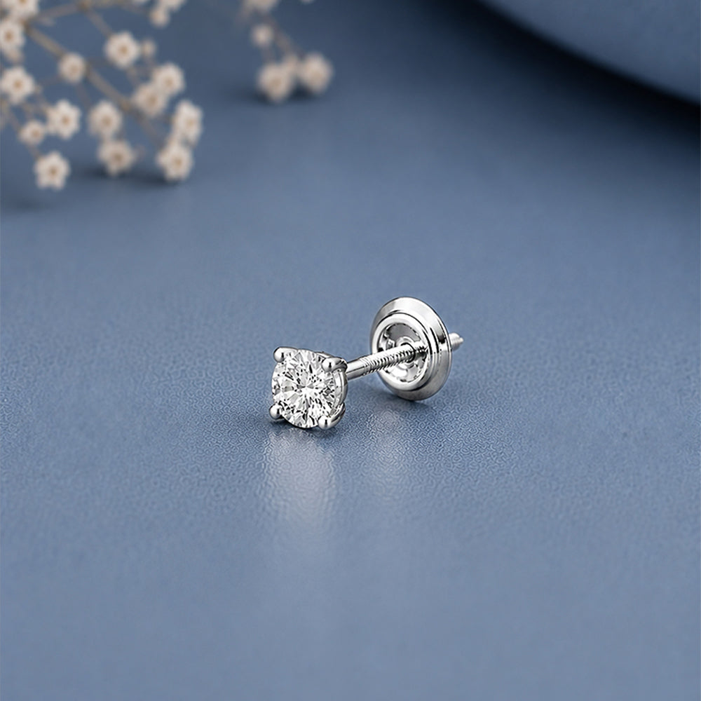 A single silver stud earring with a square-cut 