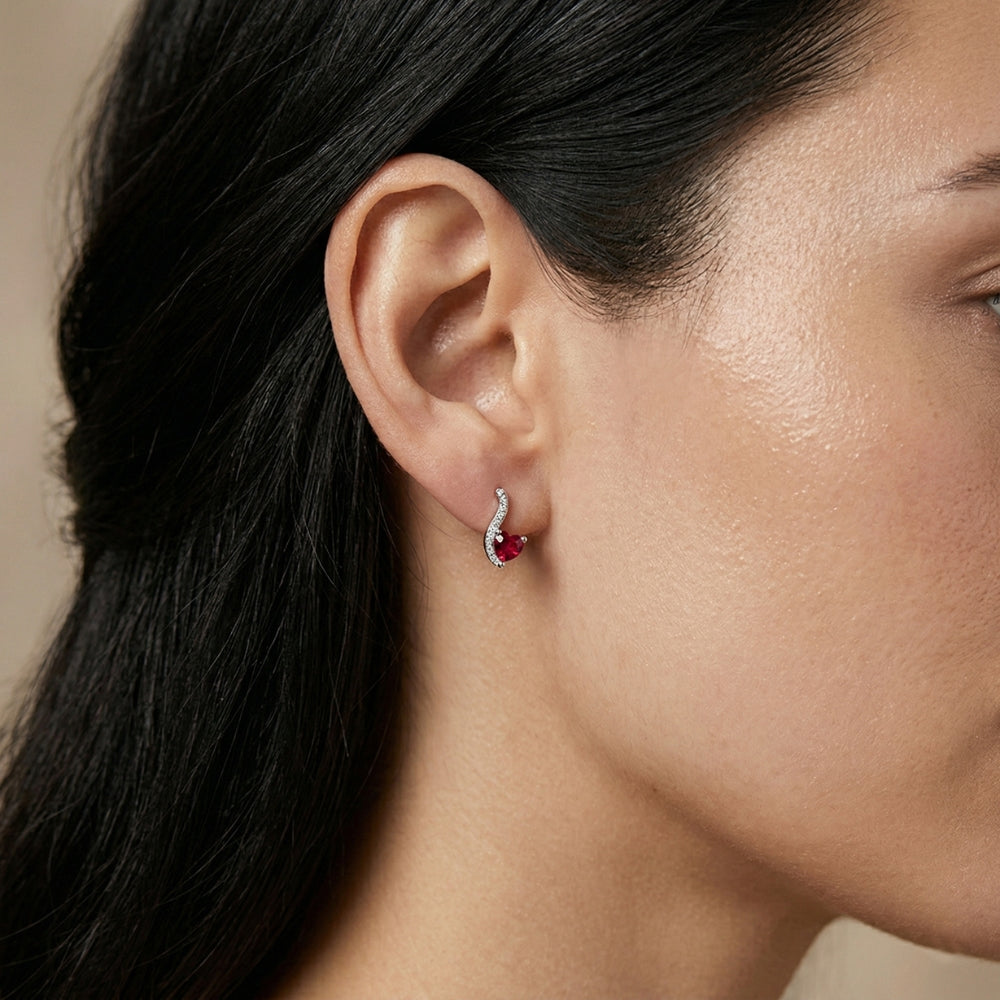Close-up of a woman wearing a red gemstone earring 