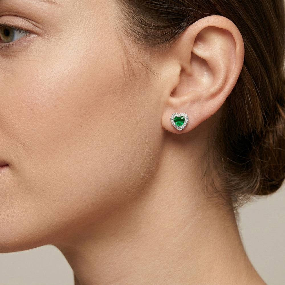 woman wearing green heart-shaped earrings.