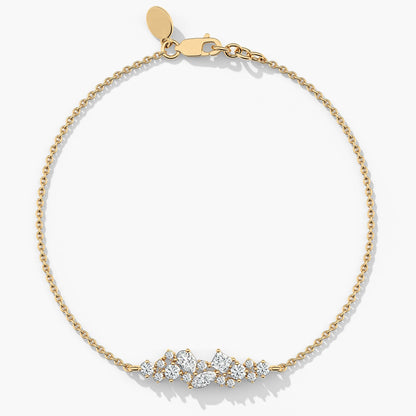 yellow Gold plated bracelet with diamond-like stones on a white background